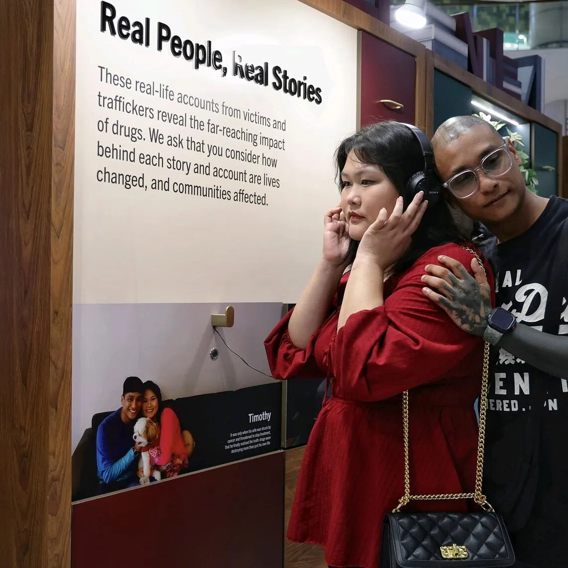 Former drug abuser Timothy York James and his wife Eleanore Lim listen to their story during the Drug Victims Remembrance Day observance at Suntec City Atrium on May 15, 2026. 