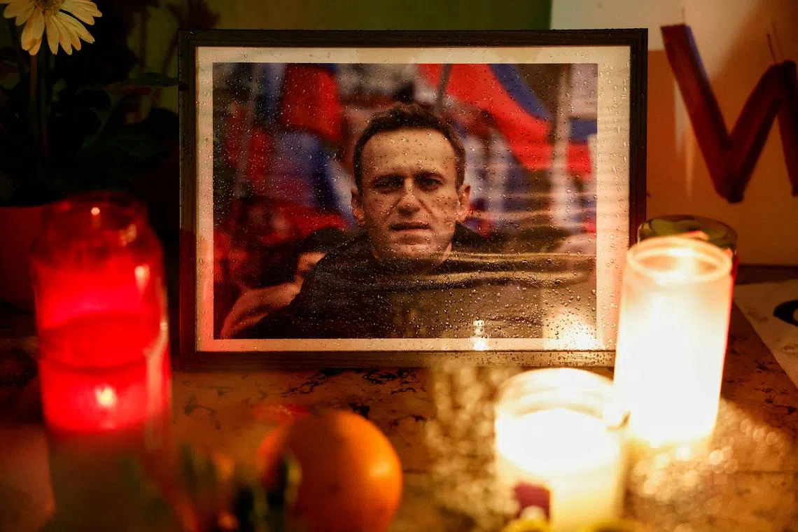 FILE PHOTO: Candles burn as people attend a vigil following the death of Russian opposition leader Alexei Navalny, at the Trocadero near the Eiffel Tower in Paris, France, February 19, 2024. REUTERS/Benoit Tessier/File Photo