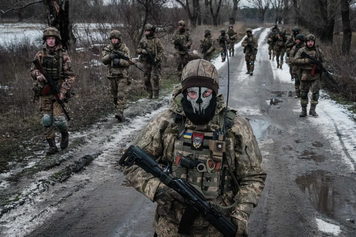 Ukrainian servicemen walk towards their base near the front line, in Ukraine's Donetsk region.