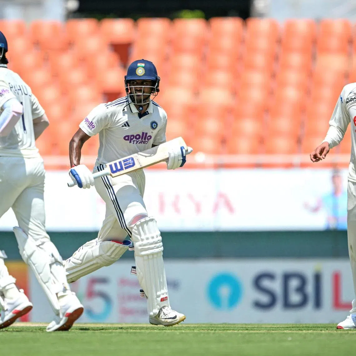 India's Sai Sudharsan (centre) and K.L. Rahul run between the wickets as Afghanistan's Ziaur Rahman watches during the first day of their only Test cricket match at the Maharaja Yadavindra Singh International Cricket Stadium on the outskirts of Chandigarh on June 6, 2026.