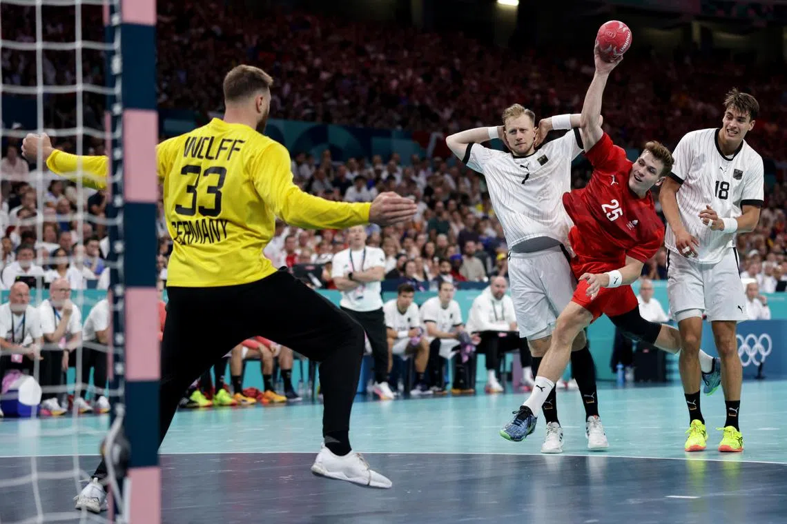 Lucas Joergensen of Denmark taking a shot at Germany goalkeeper Andreas Wolff in the Paris Olympics men's handball final at the Pierre Mauroy Stadium in Villeneuve-d'Ascq on Aug 11, 2024.