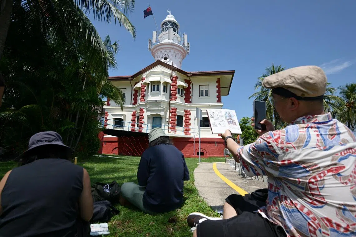 Designer and illustrator James Lim (right), 39, a member of the Urban Sketchers sketching the Sultan Shoal Lighthouse with fellow members during a public tour to the lighthouse on June 5.