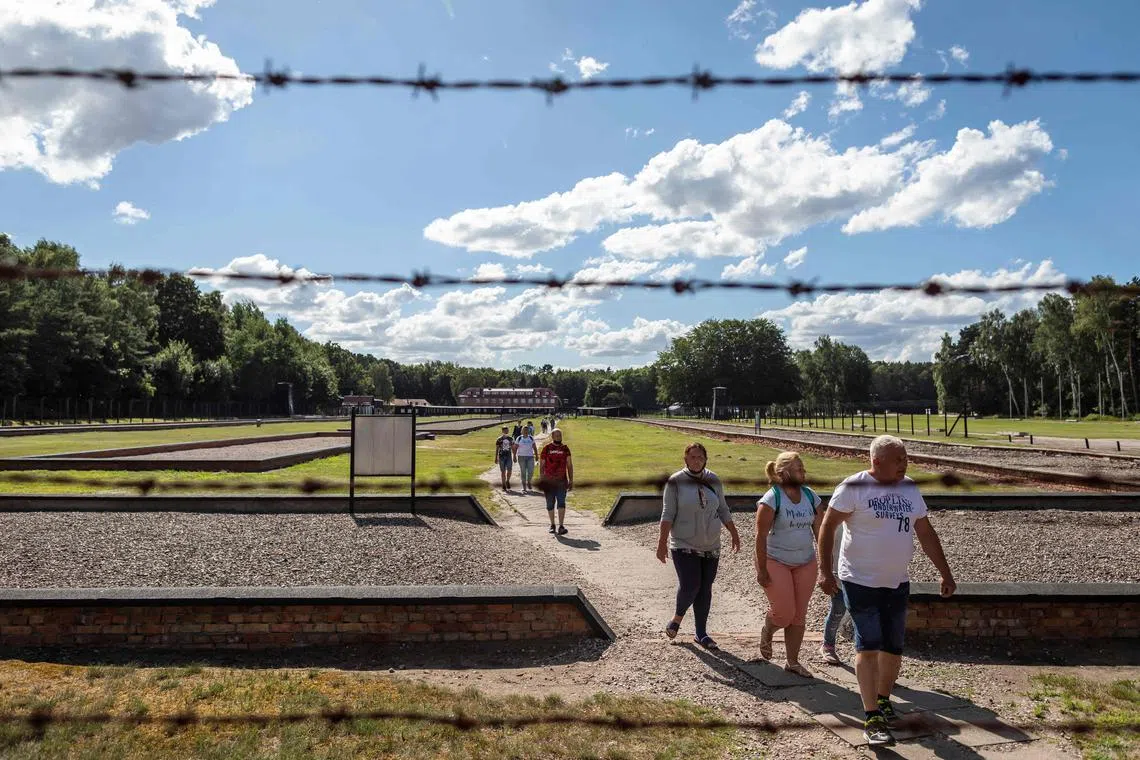 A 2020 photo shows people visiting a former World War II Nazi death camp, in Sztutowo, Poland.