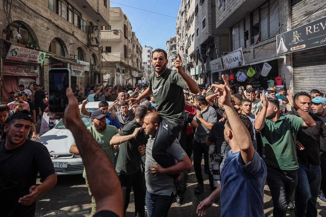EDITORS NOTE: Graphic content / Family and friends chant as they carry the body of Ahmed Al-Batsh, commander of the Al-Qassam Brigades for burial, after he was killed by an Israeli airstrike on his car, in Gaza City on September 15, 2026. The United Nations called September 15, for international investigators to be granted to access to all of Gaza "to assist with evidence-gathering" as hundreds of Palestinian bodies are pulled from the rubble. "The discovery of extensive remains under the rubble in Gaza City resurfaces these concerns of war crimes and other atrocity crimes," UN rights chief Volker Turk said in a statement. (Photo by Omar AL-QATTAA / AFP)