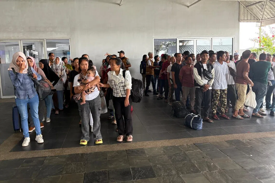 A group of repatriated Indonesians waiting for the next leg of their journey after arriving at Batam Centre International Ferry Port from Johor Bahru in August.