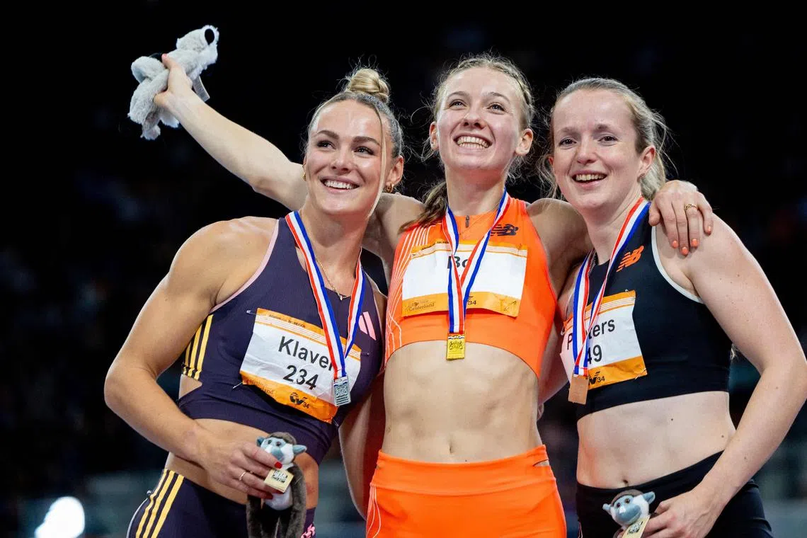 Netherlands' Femke Bol (C) celebrates with compatriots Lieke Klaver (L) and Cathelijn Peeters (R) on the podium after her world record victory in the women's 400m final during the second day of the Dutch indoor athletics championships at Apeldoorn on February 18, 2024. Femke Bol broke her own indoor 400m world record as she recorded a time of 49.24sec in the Dutch championships in Apeldoorn. Bol, the double world champion outdoors at 400m hurdles, improved her own record set last year by two hundredths of a second. (Photo by Iris van den Broek / ANP / AFP) / Netherlands OUT