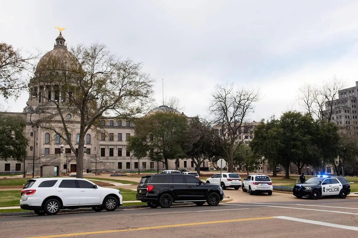 Police cars are deployed at the Mississippi State Capitol, after a bomb threat was received, in Jackson, Mississippi.