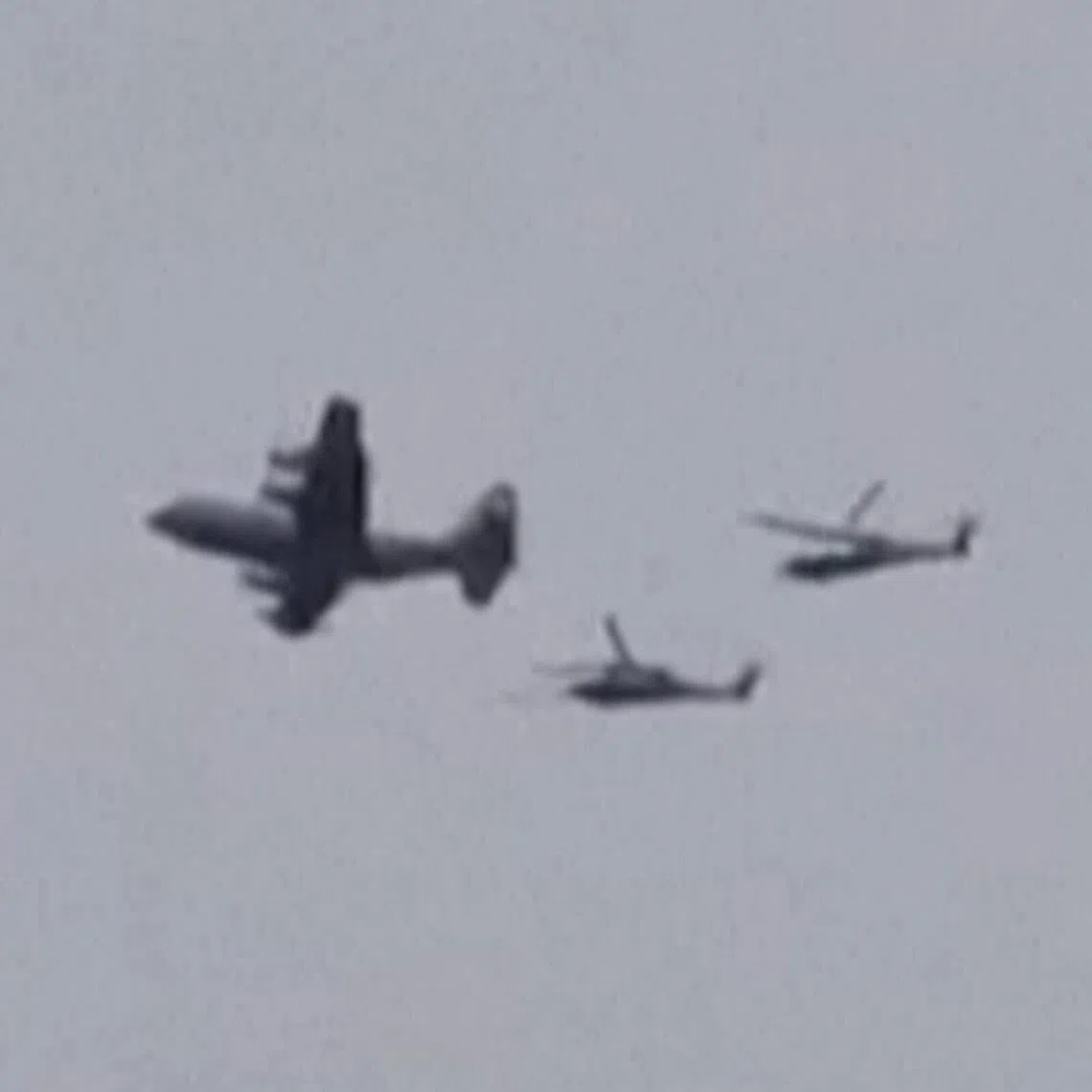 A US aircraft, followed by two helicopters, flying over the town of Zaras in southern Iran's Khuzestan province.