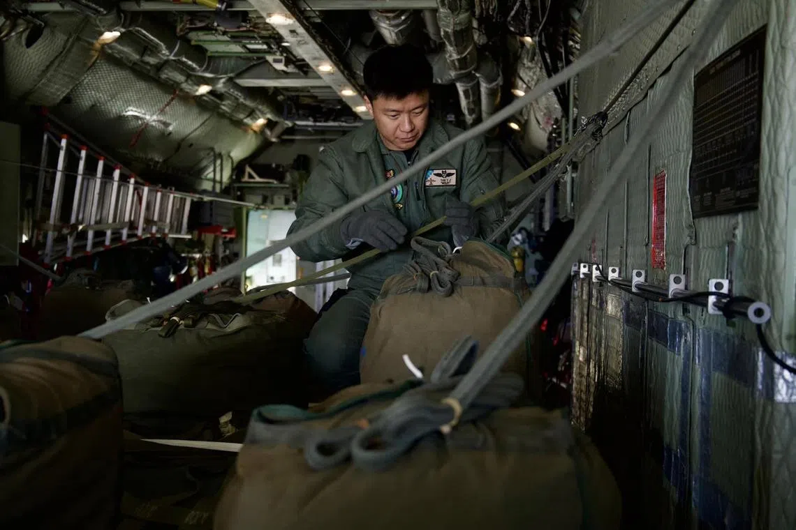 The RSAF's loadmaster conducting final safety checks before the C-130 takes off for the airdrop mission.