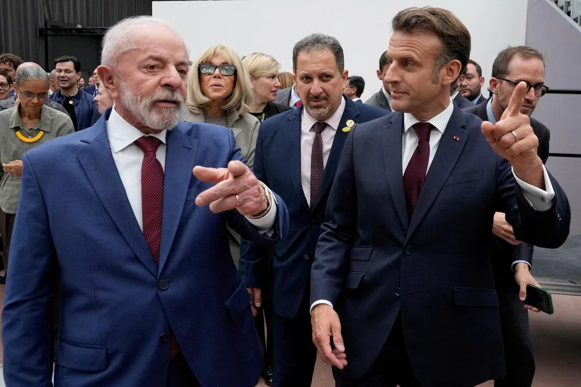 FILE PHOTO: Brazil's President Luiz Inacio Lula da Silva and French President Emmanuel Macron leave after visiting an exhibition by Brazilian artist Ernesto Neto Friday, June 6, 2025 at the Grand Palais museum in Paris, France.      Michel Euler/Pool via REUTERS/File Photo