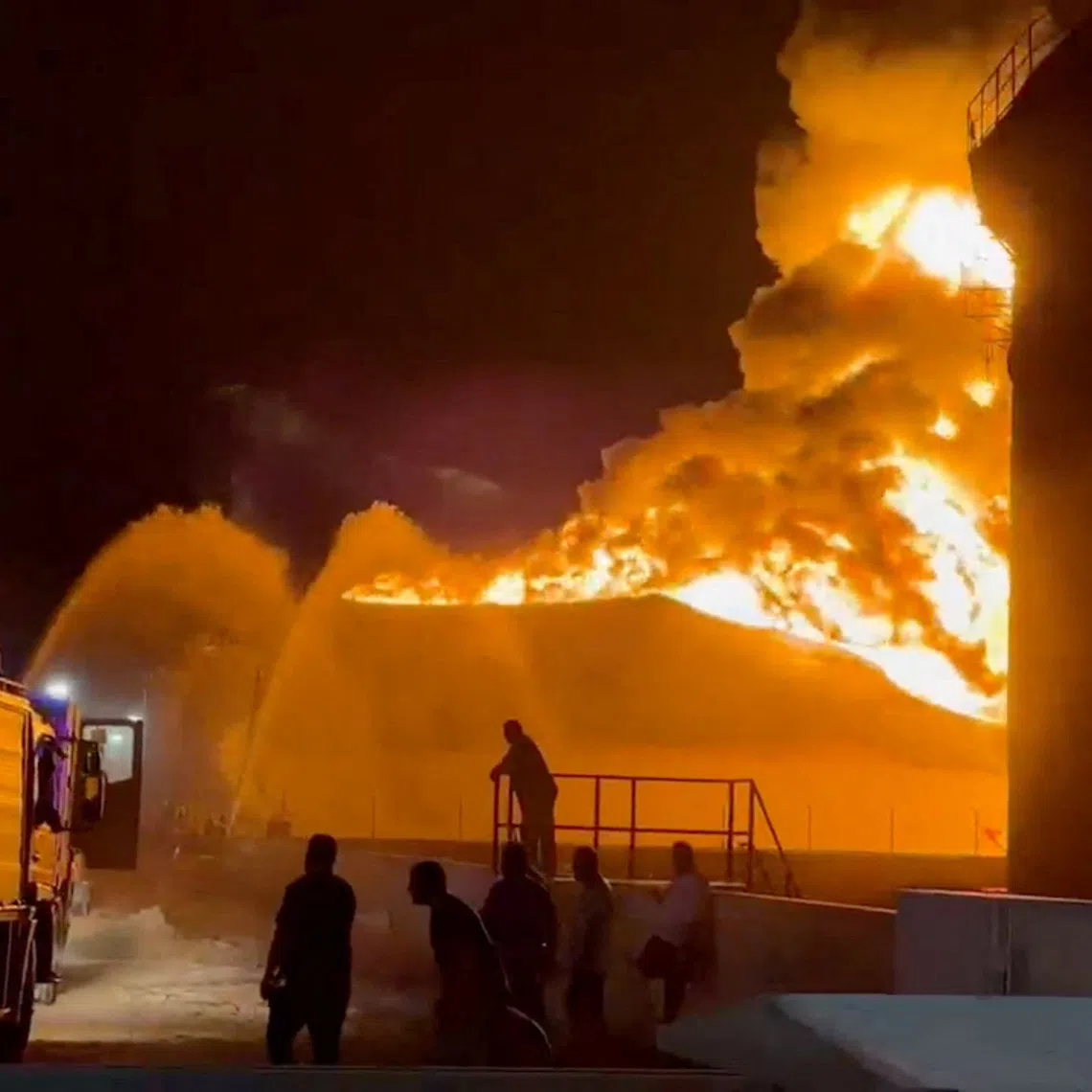 A fire in a storage tank burns as firefighters work to control the blaze, at an oil refinery in Zawiya, Libya August 10, 2026, in this still image from video obtained by Reuters. Video obtained by Reuters/via REUTERS