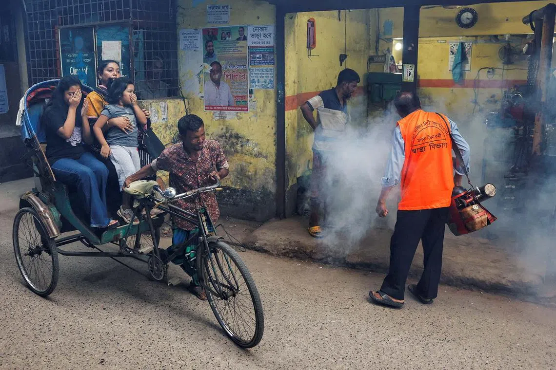 A municipal worker using a fumigator to control mosquitoes, as the number of dengue infected patients increases in Dhaka, Bangladesh, Oct 14, 2024. 