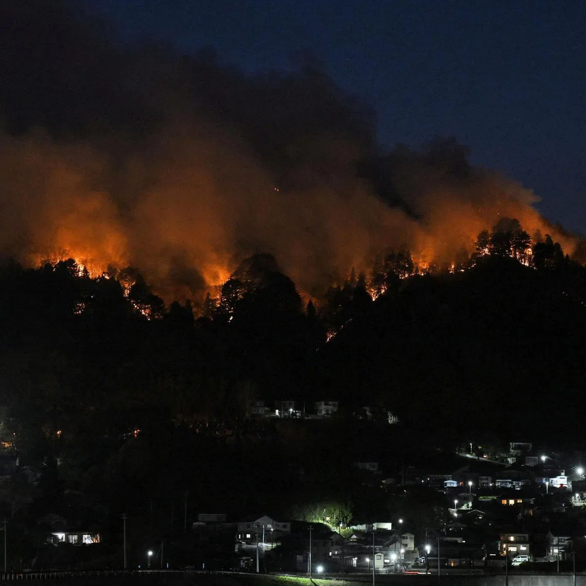 A wildfire burns near the Kirikiri district of Otsuchi, Iwate Prefecture, Japan, on April 24, 2026, as wildfires continue, following their outbreak at two locations in northeastern Japan two days ago, in this photo taken by Kyodo.