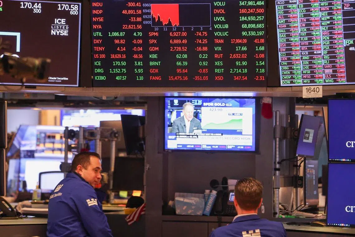 Traders working on the floor of the New York Stock Exchange in New York, on Jan 14, 2026. 