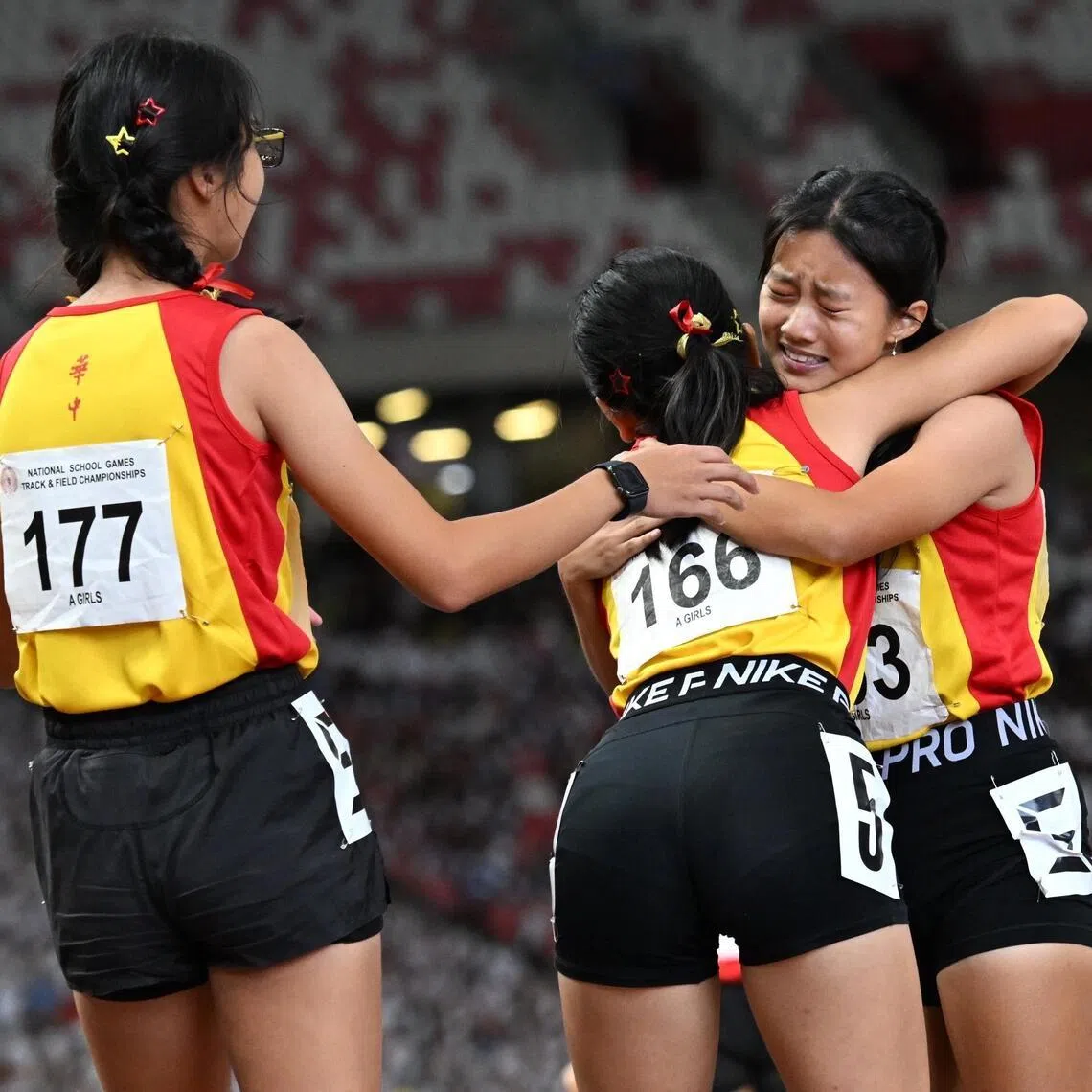 From right: Hwa Chong Institution?s Choo Jiayi celebrating with her teammates Huang Tianai and Sun Lanning after winning the A Division girls' 4X400m relay in the National School Games SSC Track and Field Championship on April 17, 2026.