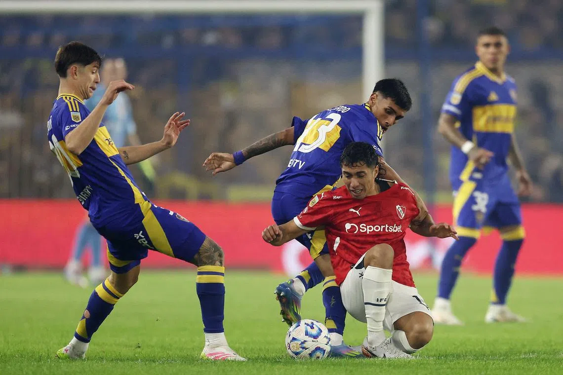 Independiente midfielder Luciano Cabral being tackled by Boca Juniors midfielder Milton Delgado in the Argentine Professional Football League Apertura Tournament quarter-final at La Bombonera stadium in Buenos Aires on May 19, 2025.