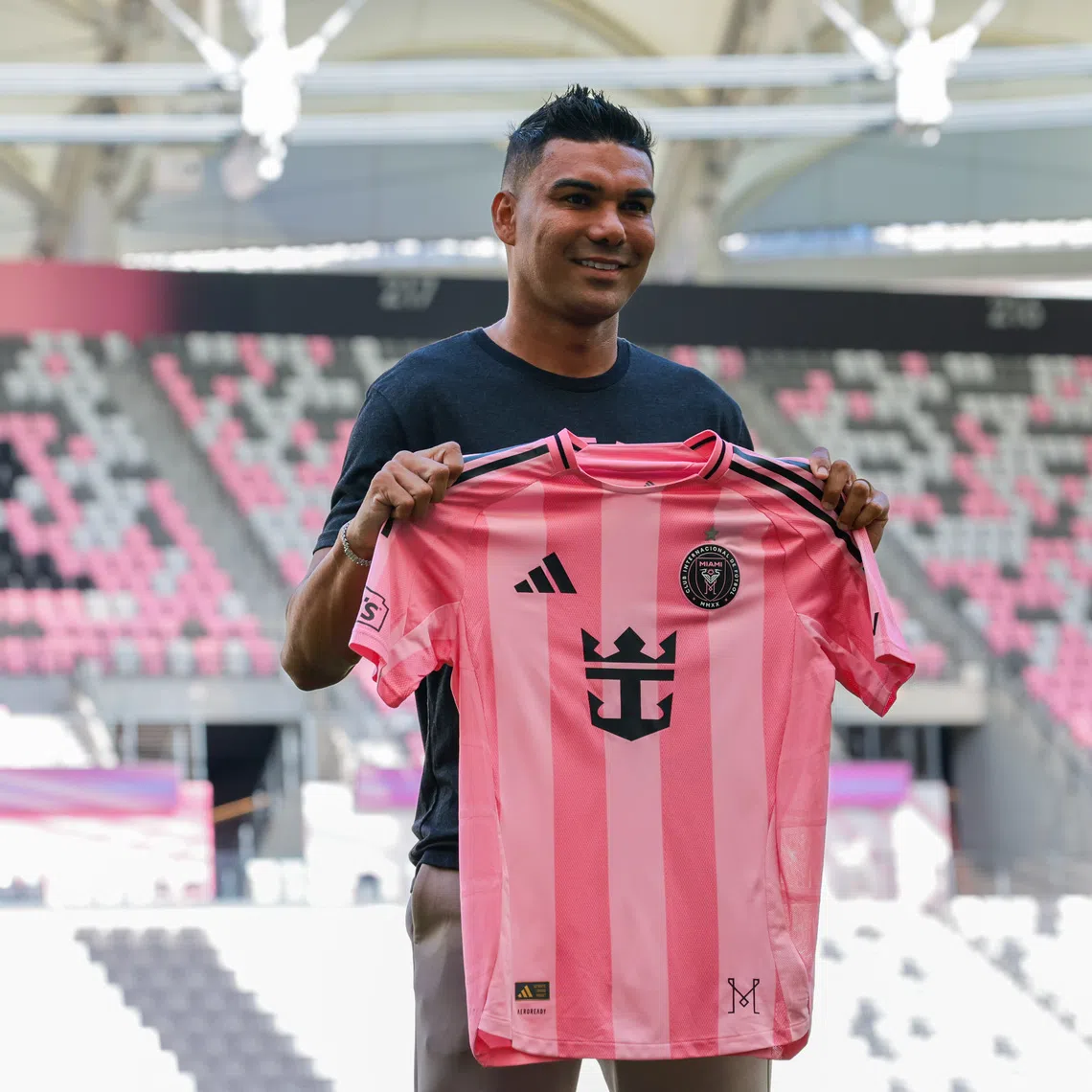 Jul 30, 2026; Miami, FL, USA; Inter Miami CF midfielder Casemiro (5) poses with a jersey during his presentation as a new member of the team at Nu Stadium. Mandatory Credit: Sam Navarro-Imagn Images