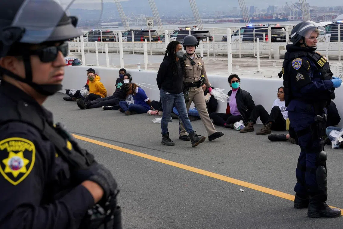 Security detaining people who demonstrated at the San Francisco Bay Bridge, calling for a ceasefire in the ongoing conflict between Israel and Hamas, on Nov 16.