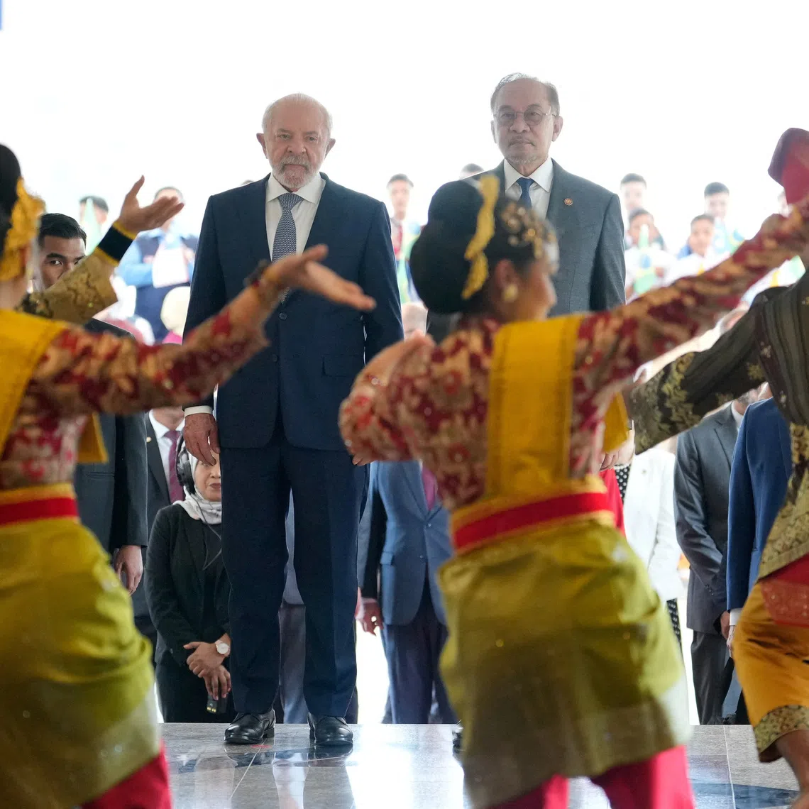 Brazilian Luiz Inacio Lula da Silva (left) and Malaysian Prime Minister Anwar Ibrahim being welcomed by traditional dance performers in Putrajaya, Malaysia, on Oct 25.