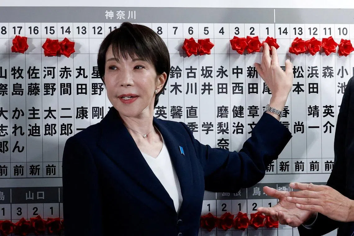 Japan's Prime Minister Sanae Takaichi, leader of the ruling Liberal Democratic Party (LDP), places a red paper rose on the name of an elected candidate at the LDP headquarters on general election day in Tokyo, Japan, February 8, 2026. REUTERS/Kim Kyung-Hoon/Pool