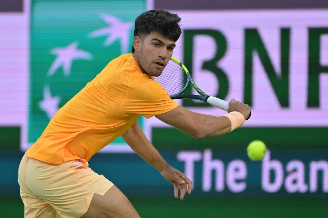Mar 7, 2026; Indian Wells, CA, USA;  Carlos Alcaraz (ESP) hits a shot as he defeated Grigor Dimitrov (BUL) during his second round match in the BNP Paribas Open at the Indian Wells Tennis Garden. Mandatory Credit: Jayne Kamin-Oncea-Imagn Images