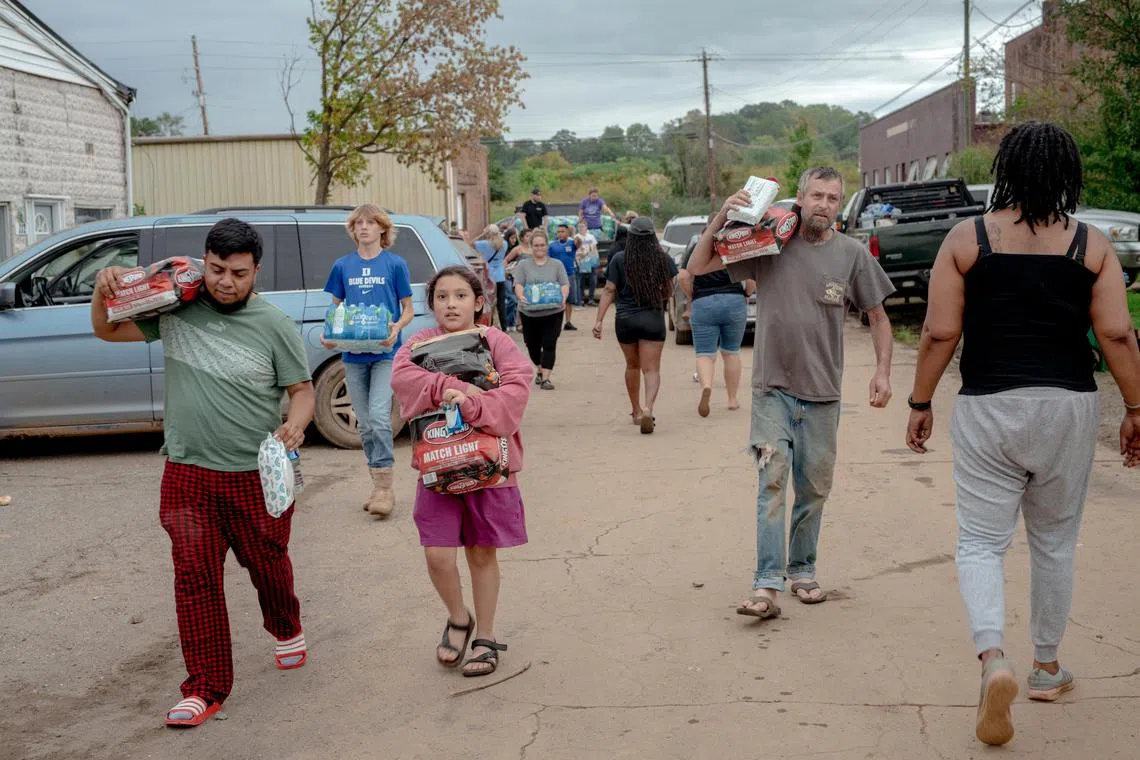 Residents collecting goods in Swannanoa, North Carolina, after the destruction wreaked by Hurricane Helene in the US South-east.