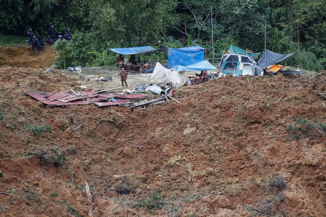 Malaysia authorities inspect the location after a landslide hit the campsite in Batang Kali, state of Selangor, Malaysia, Dec 16, 2022. 