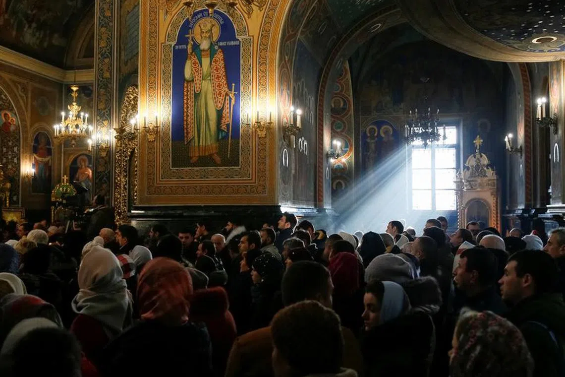 FILE PHOTO: People attend a service for Orthodox Epiphany celebrations in Chisinau, Moldova January 19, 2019.  REUTERS/Gleb Garanich/File Photo