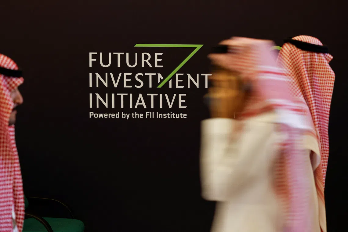Delegates walk at the venue of the Future Investment Initiative (FII) in Riyadh, Saudi Arabia Oct 29, 2024.