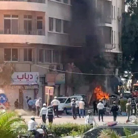 Emergency personnel working at the site of an explosion, near a hotel where French President Emmanuel Macron was meant to be staying, in Damascus, Syria, on July 7.