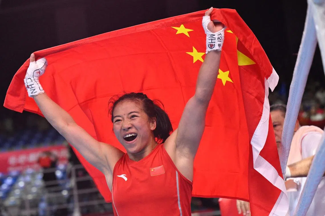 China’s Wu Yu celebrates after winning against Thailand’s Chuthamat Raksat in the women’s 45-50kg boxing final at the Asian Games.