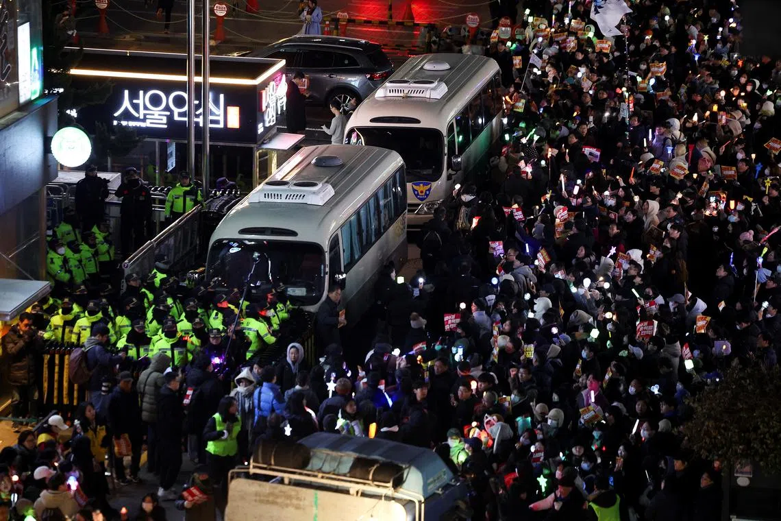 Protesters attend a rally calling for the impeachment of South Korean President Yoon Suk Yeol, who declared martial law, which was reversed hours later, in front of the headquarters of the ruling People Power Party, in Seoul, South Korea, December 10, 2024. REUTERS/Kim Hong-Ji
