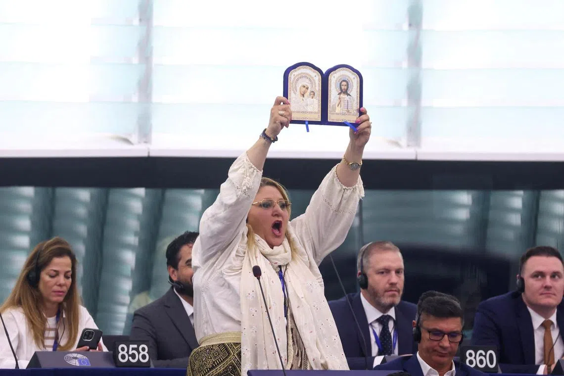 FILE PHOTO: Diana Iovanovici-Sosoaca, European Parliament member and a far-right Romanian politician, holds up religious icons, before a vote to choose the next President of the European Commission, at the European Parliament in Strasbourg, France, July 18, 2024. REUTERS/Johanna Geron/File Photo