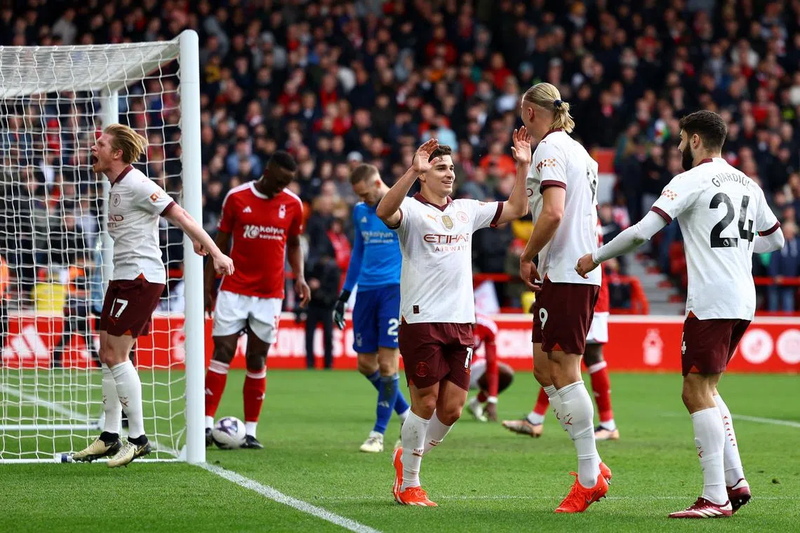 Soccer Football - Premier League - Nottingham Forest v Manchester City - The City Ground, Nottingham, Britain - April 28, 2024 Manchester City's Erling Braut Haaland celebrates scoring their second goal with Julian Alvarez REUTERS/Molly Darlington