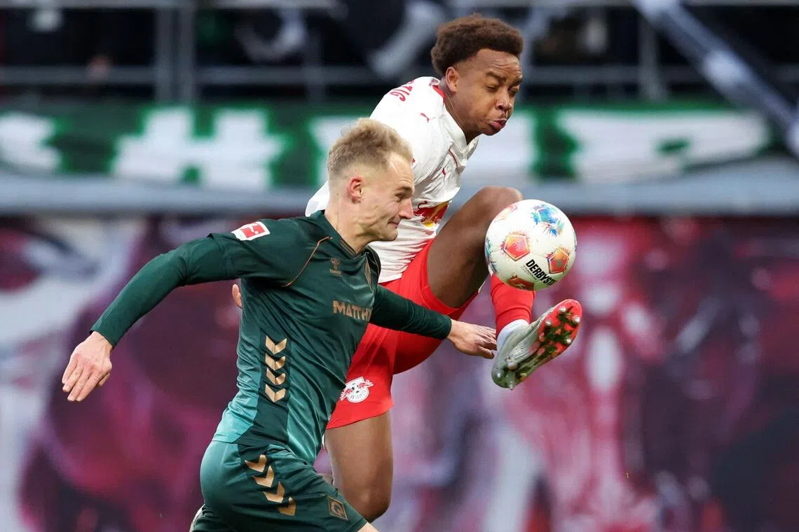 Leipzig midfielder Assan Ouedraogo and Bremen defender Amos Pieper vie for the ball in their Bundesliga football match on Nov 23, 2025.
