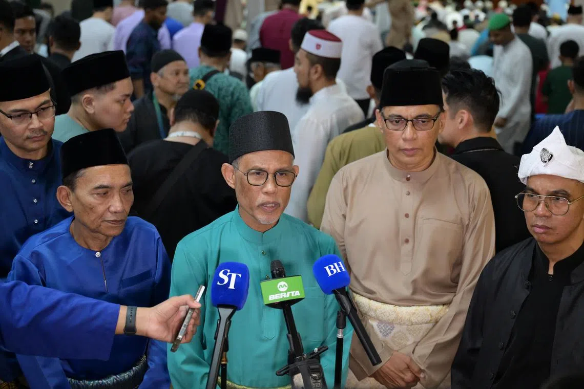 Minister for Social and Family Development Masagos Zulkifli (centre) speaking to the media at Masjid Al-Iman on March 31.