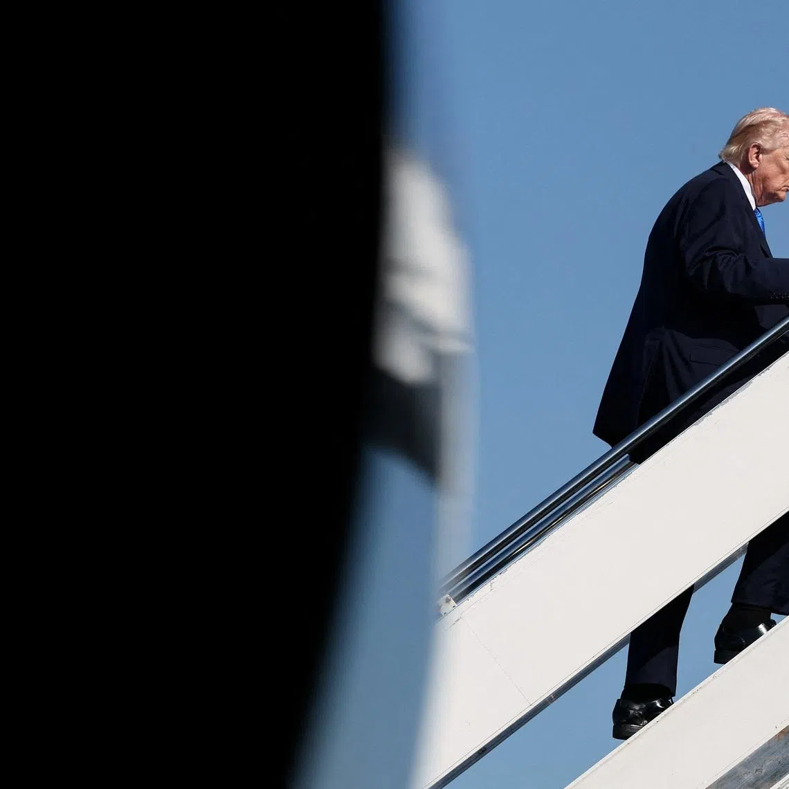 U.S. President Donald Trump boards Air Force One as he departs West Palm Beach, Florida, U.S., March 23, 2026. REUTERS/Kevin Lamarque