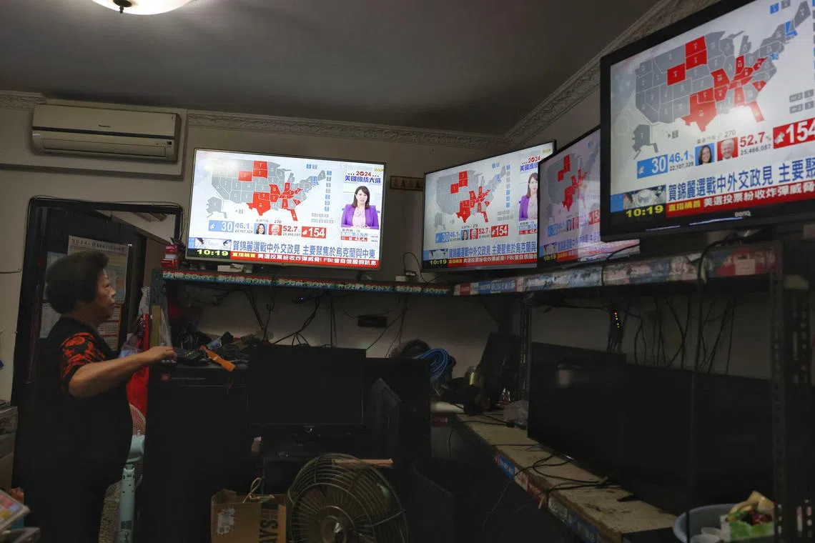 A woman tracks the US presidential election in Taipei on Nov 6.