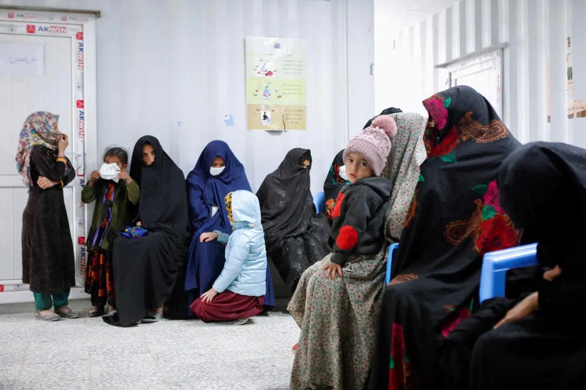 FILE PHOTO: Afghan women and children wait for their turn to see a doctor at Yaka Dokan health clinic run by nonprofit organization World Vision, in Yaka Dokan village, Herat, Afghanistan, October 23, 2024. REUTERS/Sayed Hassib/File Photo