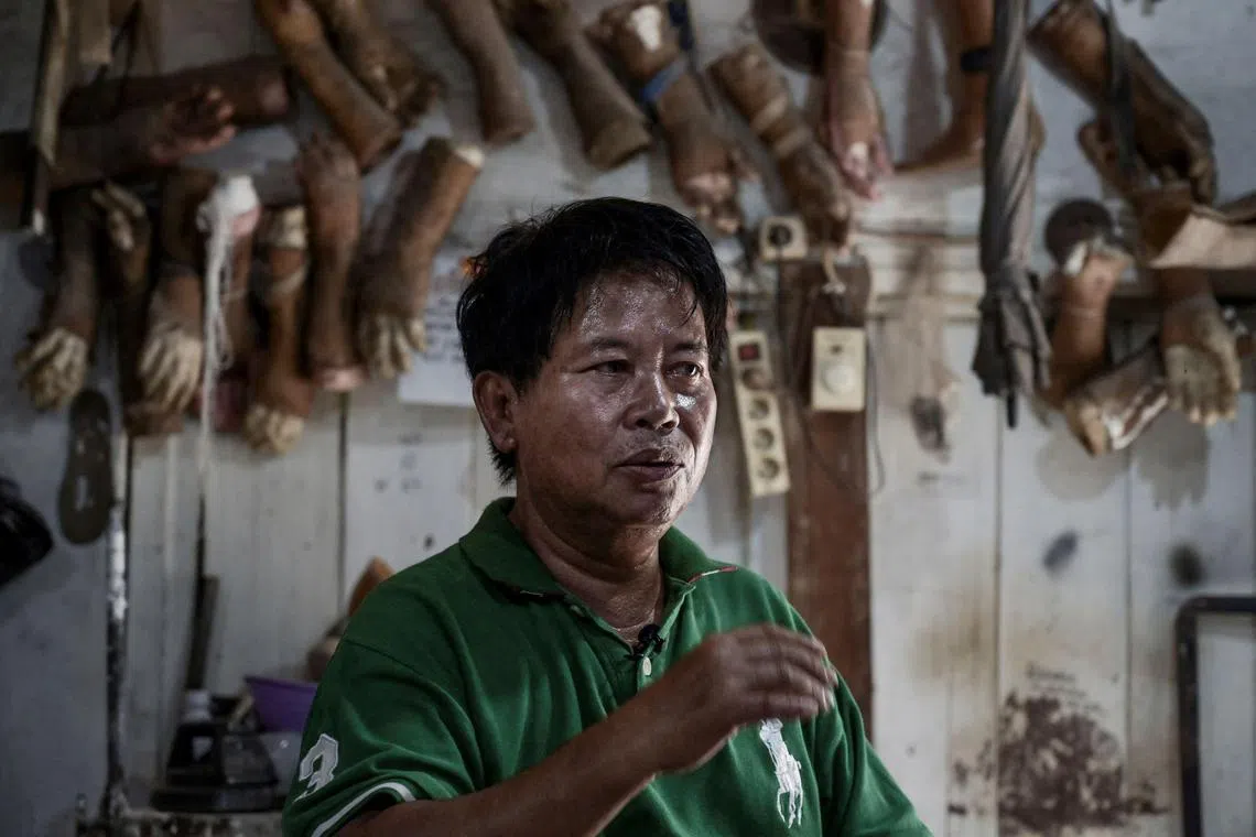 This photo taken on Jan 18, 2023 shows former leprosy patient Ali Saga speaking about his experience in becoming a self-taught maker of prosthetic legs and hands inside his workshop in Tangerang.