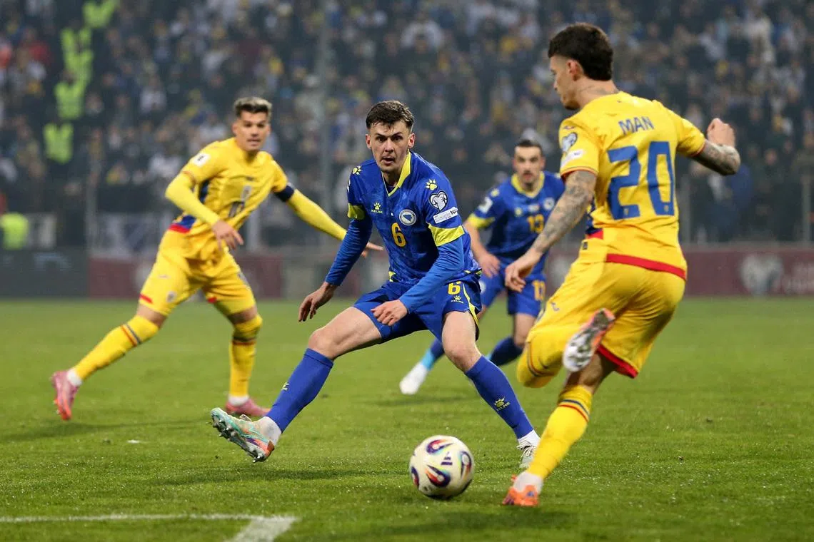 FILE PHOTO: Soccer Football - FIFA World Cup - UEFA Qualifiers - Group H - Bosnia and Herzegovina v Romania - Stadion Bilino Polje, Zenica, Bosnia and Herzegovina - November 15, 2025 Romania's Dennis Man in action with Bosnia and Herzegovina's Benjamin Tahirovic. REUTERS/Amel Emric/File Photo