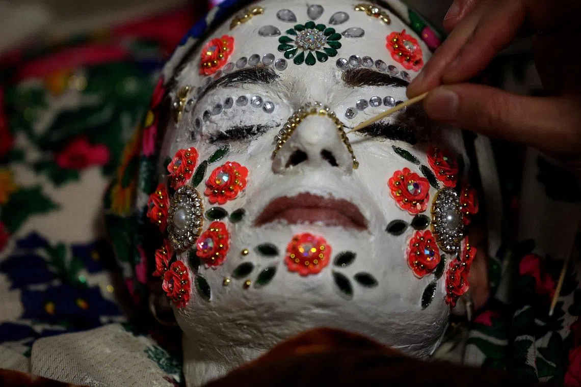 Bulgarian Muslim bride, Aysel Gerova, 24, receives the finishing touches of makeup during her traditional winter wedding ceremony in the picturesque village of Ribnovo, nestled in the Rhodope Mountains, Bulgaria, on Dec 17. The village has preserved its unique wedding customs despite decades of Communist rule.