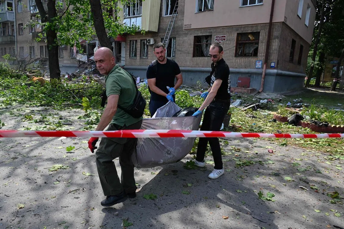 The body of a local resident is removed from the site of a Russian missile attack in Kharkiv, Ukraine, on July 8.