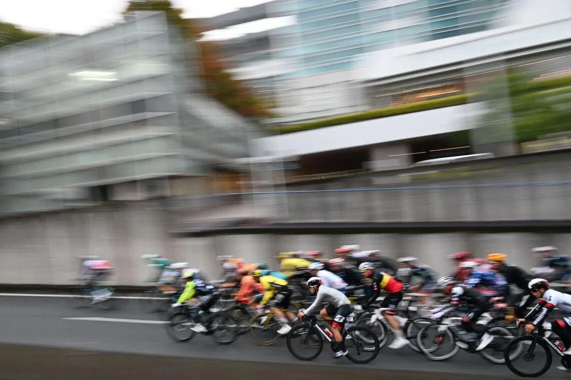The peloton riding through city streets during the Tour de France Saitama Criterium cycling race in Saitama in November 2025.