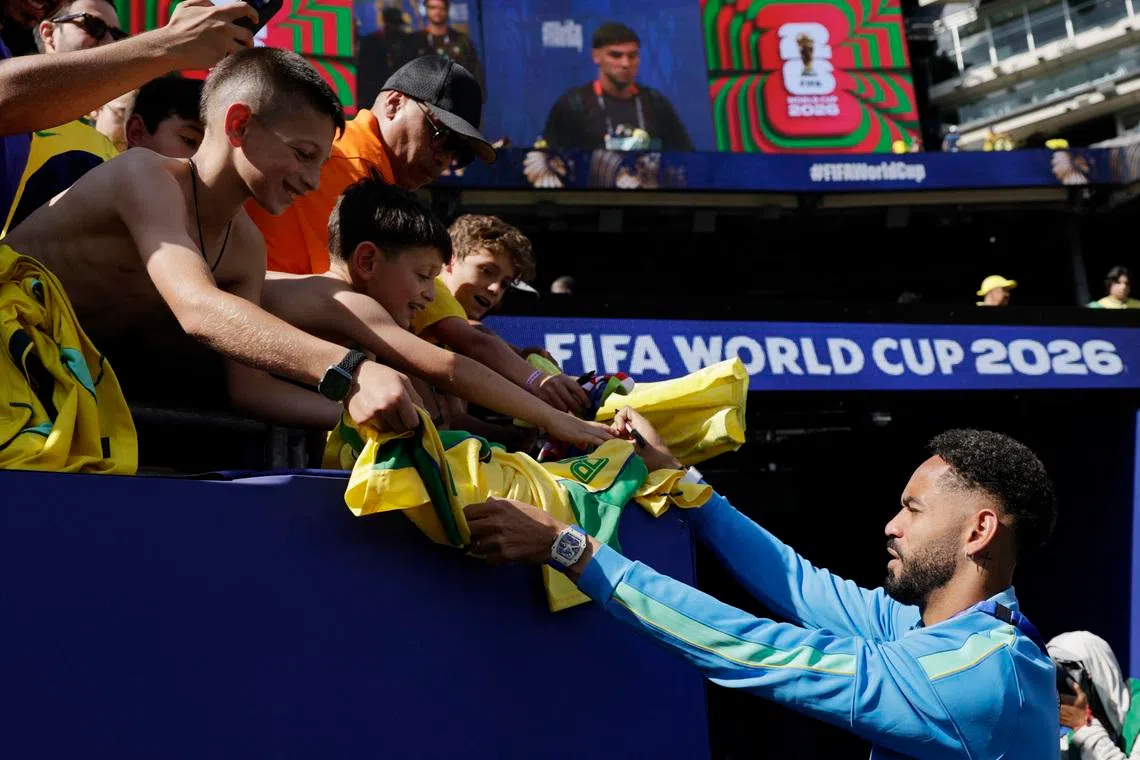 Soccer Football - FIFA World Cup 2026 - Group C - Brazil v Morocco - New York/New Jersey Stadium, East Rutherford, New Jersey, U.S. - June 13, 2026 Brazil's Matheus Cunha signs autographs for fans inside the stadium before the match REUTERS/Jeenah Moon