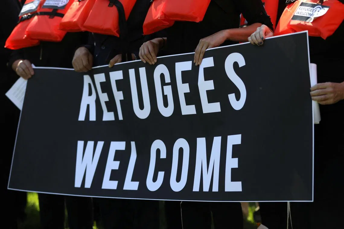 FILE PHOTO: People protest against planned Trump administration cuts to the U.S. refugee resettlement program, in front of the U.S. Capitol Building in Washington, U.S., October 15, 2019. REUTERS/Leah Millis/File Photo