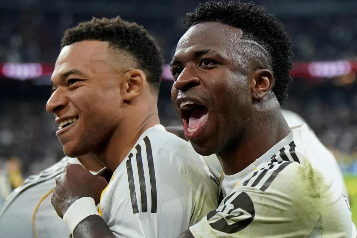 Real Madrid's Kylian Mbappe (left) celebrates scoring a late winner in the 2-1 La Liga triumph over Rayo Vallecano with Vinicius Jr at the Santiago Bernabeu on Feb 1, 2026.