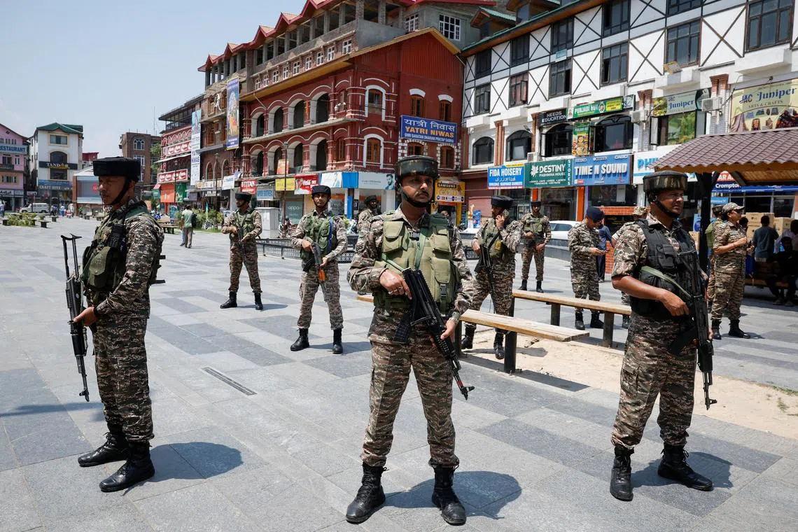 Indian security personnel stand guard on a street during the sixth anniversary of the revocation of Jammu and Kashmir's partial autonomy, splitting the state into the two federally administered territories of Jammu and Kashmir and Ladakh, in Srinagar, Indian Kashmir, August 5, 2025. 