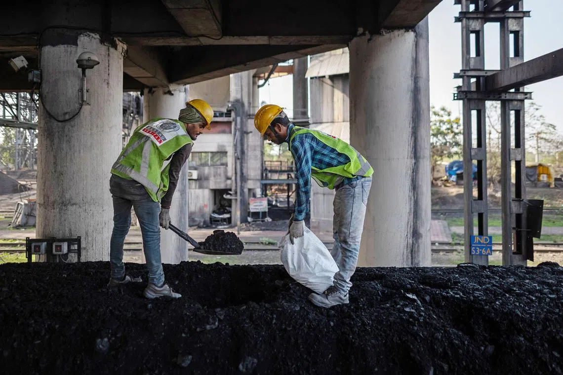 Mining workers collect samples for quality checks at the coal mine, operated by South Eastern Coalfields in Gevra, India.