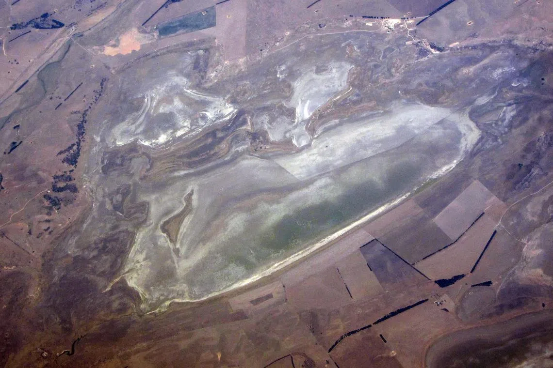A lake with low levels of water can be seen in a drought affected farming land on the outskirts of Canberra in Australia.